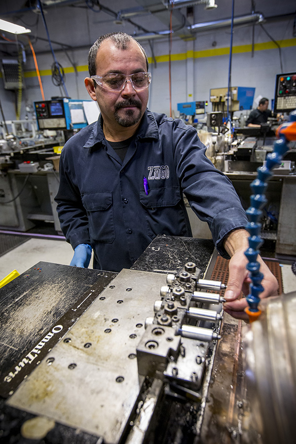 An employee working a machine at Zago Manufacturing.