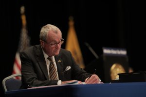 Gov. Phil Murphy signs the Fiscal Year 2021 Budget at the Trenton War Memorial on Sept. 29, 2020.