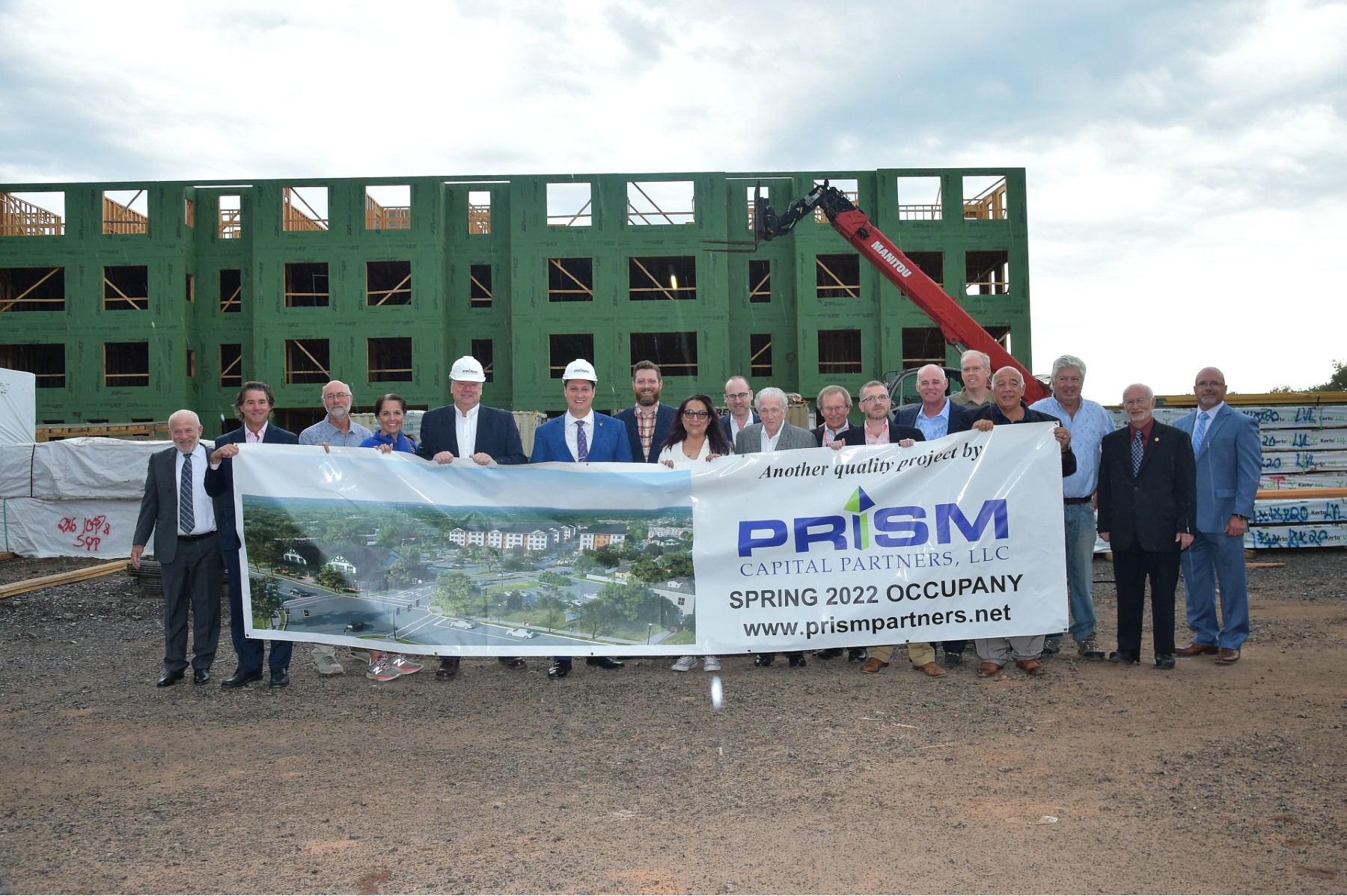 Members of Prism Capital Partners' development team, Dunellen Borough officials and other stakeholders celebrate the frame-out of Dunellen Station’s first building on Sept. 30, 2021.