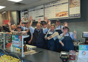 Peter Cancro, center, founder & CEO of Jersey Mike's Franchise Systems Inc., celebrates the company's Annual Day of Giving at Jersey Mike's in Point Pleasant Beach at the Jersey Shore, where it all began.