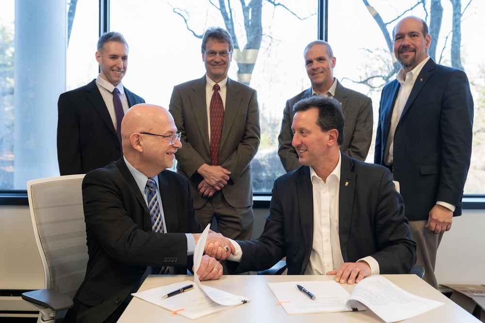 From left, Mauro Bacolo and H2M President and CEO Richard Humann shake hands. H2M announced Jan. 30, 2023, that Crew Engineers, where Bacolo served as president and senior project manager, was acquired by H2M.