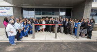 Employees gather for an April 6 ribbon-cutting for the new facility.