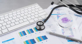 Stethoscope with financial on the desk