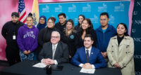 Hudson County Community College President Christopher Reber and New Jersey City University interim President Andrés Acebo sign the HCCC | NJCU CONNECT Transfer Agreement, joined by students who will take part in the program.