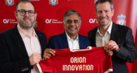Liverpool Football Club has signed a multiyear deal with Orion Innovation to become the club’s official digital transformation partner. From left: Drew Crisp, senior vice president, digital, LFC; Raj Patil, CEO, Orion Innovation; and Billy Hogan, CEO, LFC.