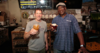 Allagash Brewing Co. brewmaster Jason Perkins and Montclair Brewery co-owner Leo Sawadogo raise a glass at Montclair Brewery’s taproom.