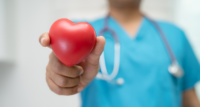 Health care provider holding heart