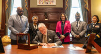 Gov. Phil Murphy (center) signed four bills at his desk on Monday Jan. 8, 2024. Joining the governor are (from left): Sen. Troy Singleton; acting Education Commissioner Angelica Allen-McMillan; Assemblymember Shama Haider; Luddie Austin; legislative director at the Department of New Jersey VFW; and Commissioner of the Department of Military and Veterans Affairs and Adjunct General of New Jersey Brig. Gen. Lisa Hou.