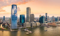 Aerial panorama of Jersey City skyline at sunset.