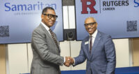 Rutgers University–Camden Chancellor Antonio Tillis and Samaritan President and CEO Phillip Heath, shake hands after signing a Memorandum of Understanding to establish a Premier Partnership, the first of its kind for both institutions.
