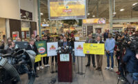 New Jersey Lottery Executive Director James Carey speaks to the crowd. Richard Saker, president and CEO of Saker ShopRites, is pictured at left holding the $30,000 check.