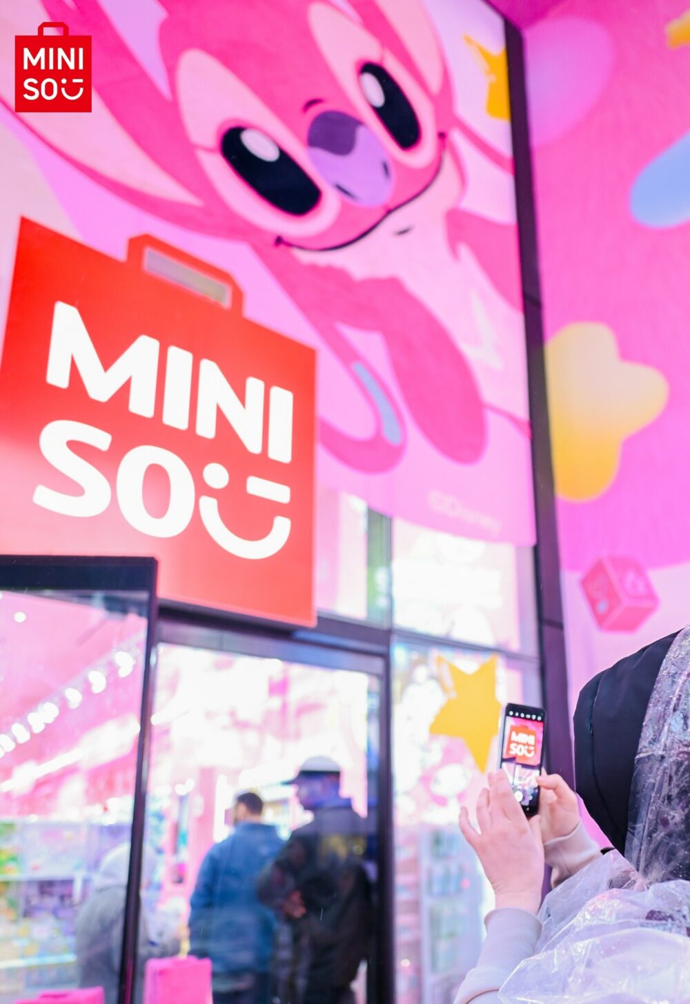 A customer takes a photo of Miniso's location in Times Square.