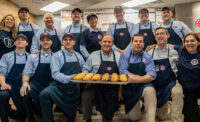 Jersey Mike’s Subs founder and CEO Peter Cancro (kneeling, center) celebrates the brand's 14th annual Day of Giving on March 27, 2024, in Point Pleasant Beach, where it all began. He is joined by the Jersey Mike’s team as well as Bunny Flanders (kneeling, right) and Leah DelPiano (standing, left) from local charity partner The Valerie Fund.