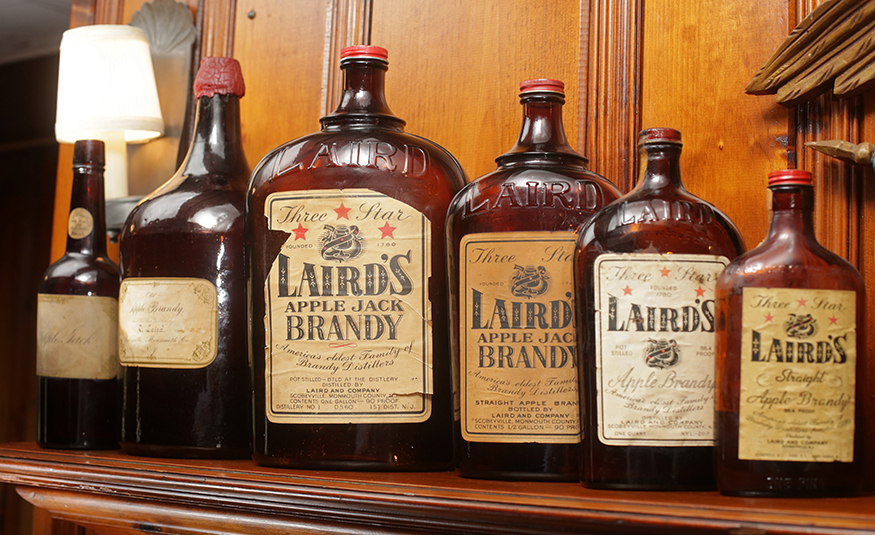 Old bottles of Laird's apple brandy displayed at Laird & Co. The bottle second from left is from the mid 1800s.