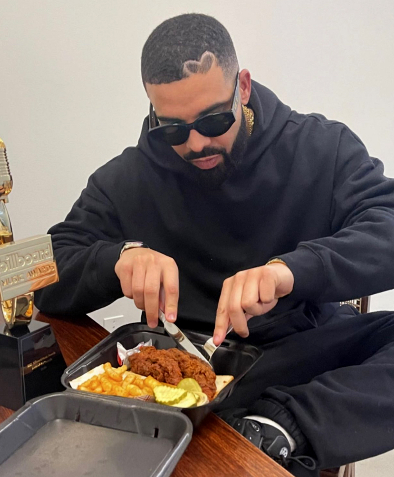 Musician and company investor Drake samples some Dave's Hot Chicken.