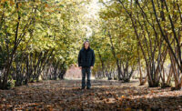 Thomas Molnar, associate professor in the Rutgers University School of Environmental and Biological Sciences, stands in a local hazelnut orchard where he and his team are supporting genetic improvement and study of hazelnuts.