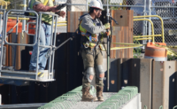 Crews work on beams with fortified bars that undergird the concrete deck in October 2024.