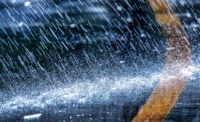 Raindrops fall on the asphalt