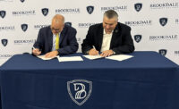 Stockton President Joe Bertolino and Brookdale Community College President David Stout renew the Transfer Pathways agreement between the schools in September 2025.