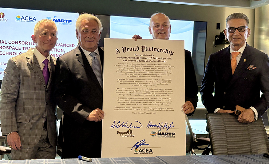 From left, U.S. Rep. Jeff Van Drew, ACEA Chair Michael Viscount, NARTP President Howard Kyle, and Rowan University President Ali Houshmand pose with a ceremonial agreement creating a new academic consortium for aerospace innovation Aug. 28 in Egg Harbor Township.