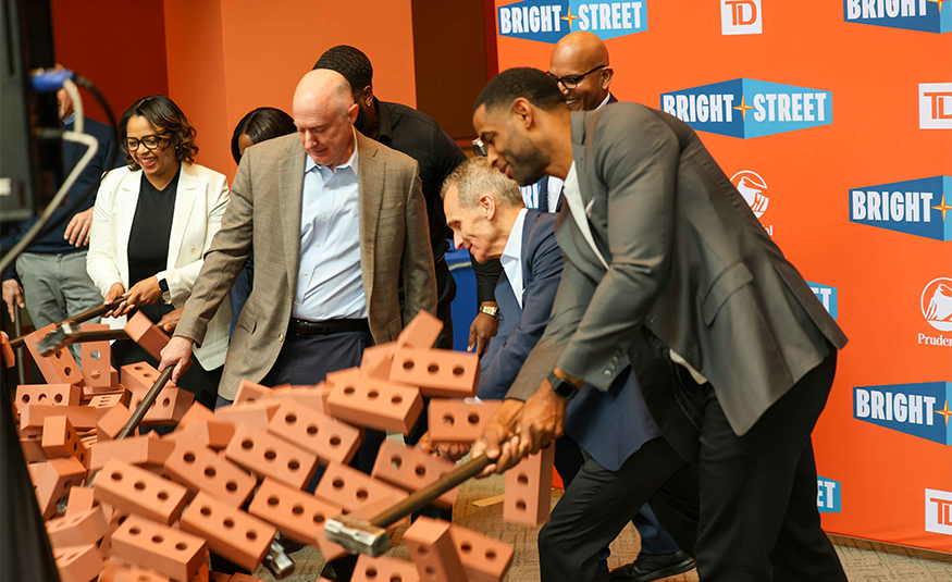 The launch event for BrightStreet featured entrepreneurs from its inaugural cohort using sledgehammers to break through a life-sized faux brick wall. The action symbolizes the organization's mission to eliminate obstacles to capital, mentorship, technology, and training for small business owners historically excluded from traditional lending. PROVIDED BY BRIGHTSTREET