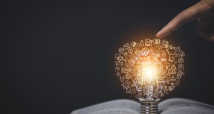 Thinking and creative concept, Light bulb on the Book and light bulb and icon style bokeh vintage dark background,Concept The idea of reading books, knowledge, and searching for new ideas.